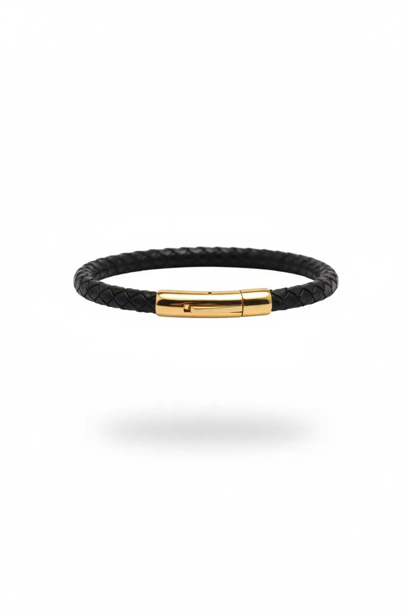 Black braided bracelet with a gold clasp on a white background