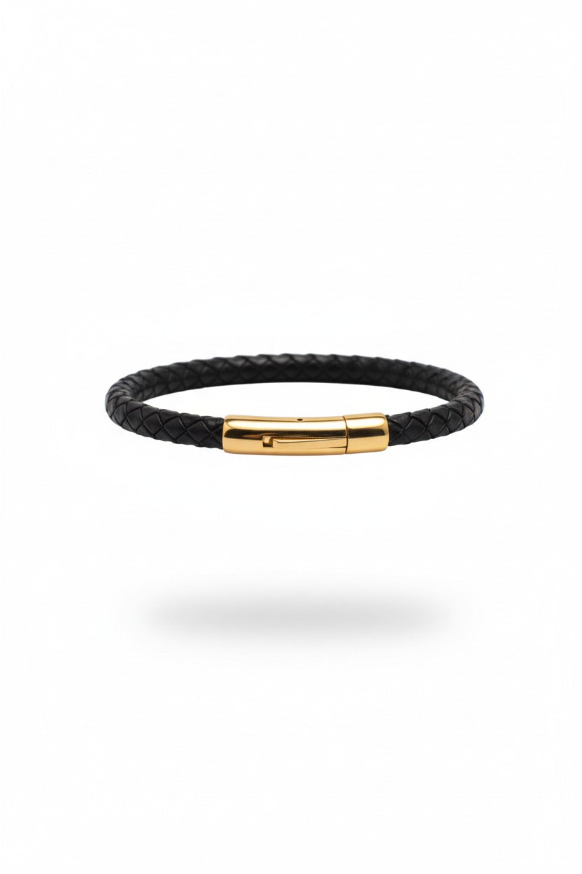 Black braided bracelet with a gold clasp on a white background